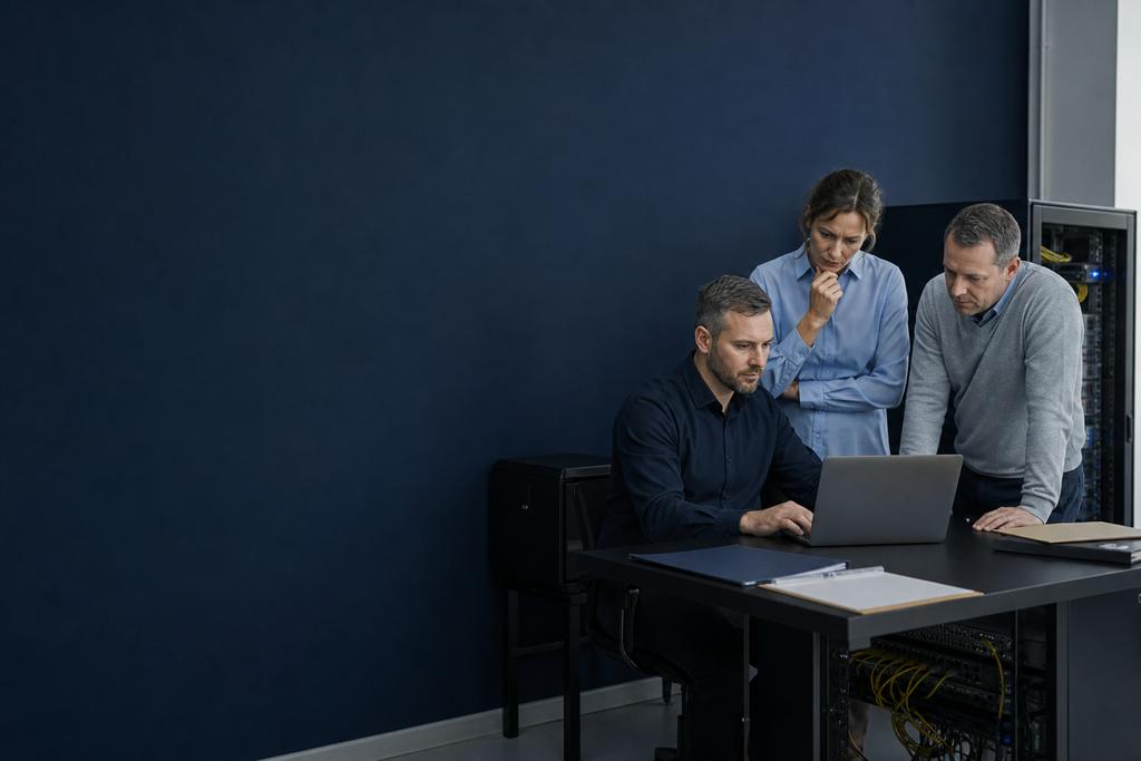Illustratieve Windows-specialisten en lokale contactpersoon die domein-, DNS- en bestandenroutes per vestiging vergelijken